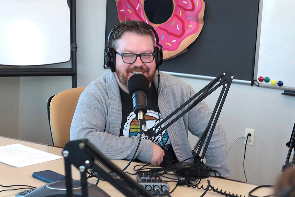 Image of James doing the Money Donuts Podcast