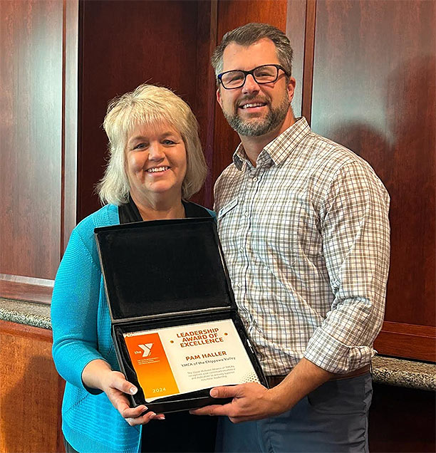 Photo of Pam holding plaque