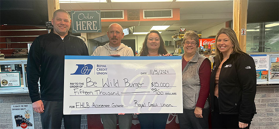 Group of business people holding a large check