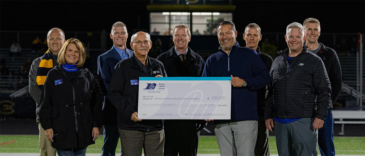 Group of leaders holding a large check