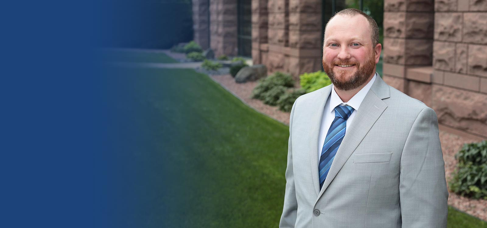 team member photo standing near building and smiling