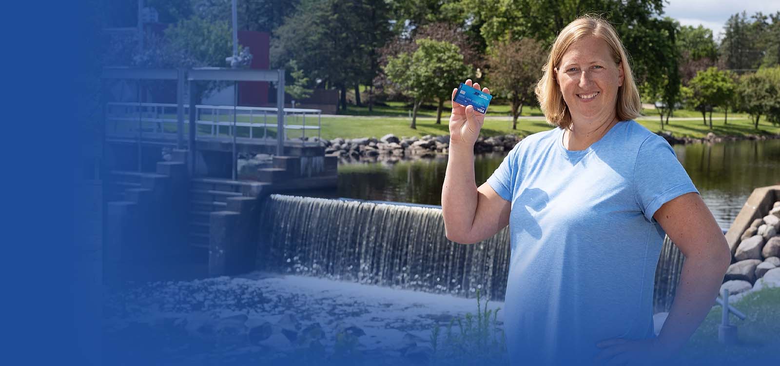 Happy woman holding RCU debit card