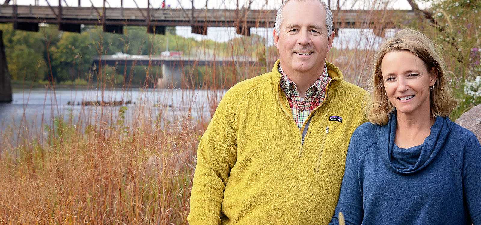 couple in front of bridge