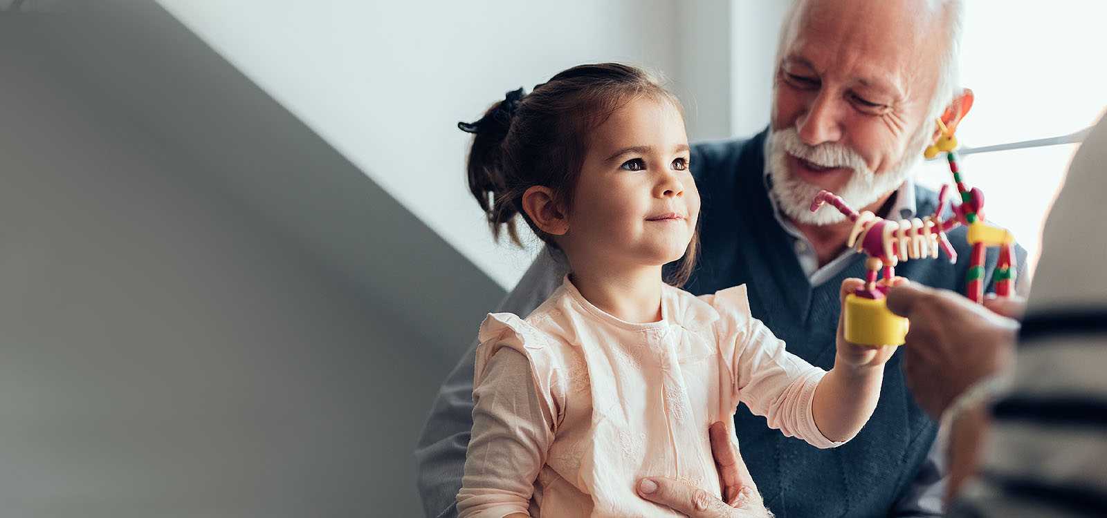 Retired man playing with grand daughter