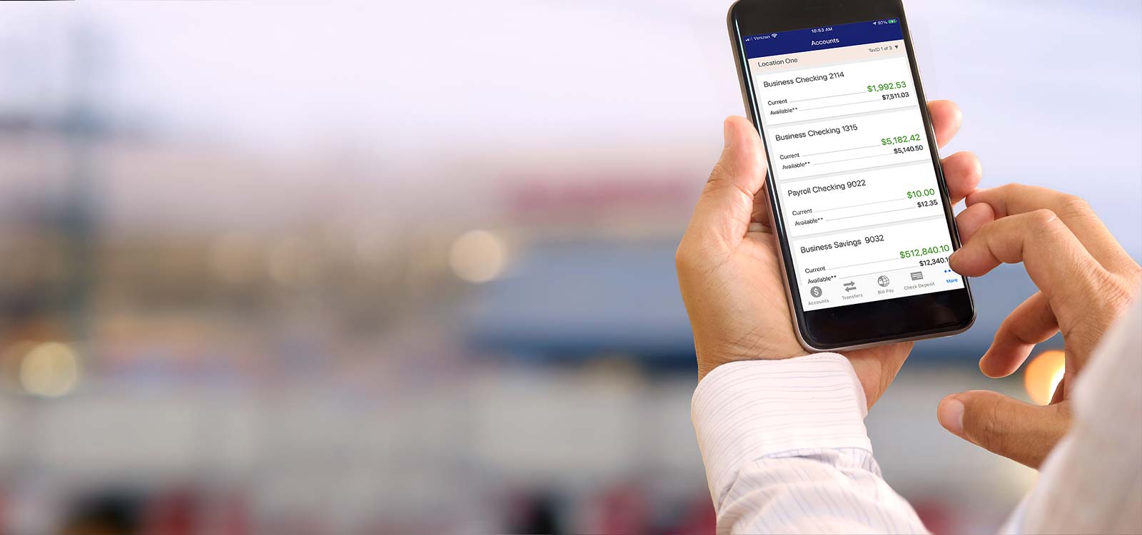 Person holding phone while banking