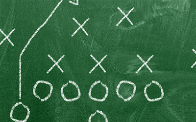 Sketch of football plays on chalkboard