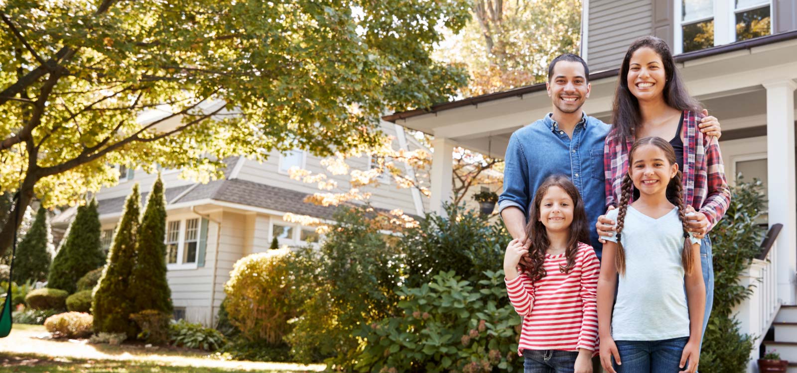 Couple standing in front of new house